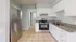 Bright modern kitchen featuring sleek stainless steel appliances, elegant granite countertops, and ample white cabinetry.