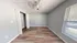 Bright, spacious bedroom with sleek hardwood floors, generous closet space, and abundant natural light from large windows.