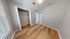 Bright bedroom with sleek hardwood floors and a spacious closet, perfect for modern living.