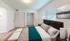 Inviting bedroom with a plush bed, modern decor, and a spacious closet, bathed in natural light from large windows.