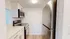 Modern kitchen with sleek stainless steel appliances, pristine white cabinetry, and elegant countertops.