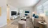 Bright and modern living room with cozy beige furniture, elegant decor, and large windows inviting natural light.