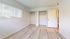 Bright and airy bedroom with large windows, spacious closets, and elegant flooring.