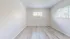 Bright and airy room with large windows, showcasing elegant light wood flooring and fresh white walls, perfect for a cozy living space.