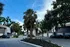 Beautiful apartment complex surrounded by lush palm trees and well-maintained landscaping, offering a serene and inviting atmosphere.