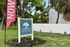 Charming Oak Park Villas sign amidst lush greenery, inviting you to explore tranquil living.