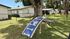 Inviting pet-friendly outdoor space featuring charming agility equipment, shaded by lush trees, nestled in a serene residential setting.