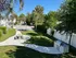 Serene outdoor space featuring a picnic area, lush green lawn, and modern barbecue grill, perfect for entertaining and relaxation.