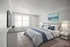 Bright and inviting bedroom with elegant decor, featuring a plush bed, stylish bedside tables, and large window allowing natural light to flood the space.