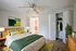 Inviting bedroom with modern decor, vibrant bedding, and ample closet space, perfect for relaxation.