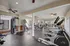 Modern fitness center with state-of-the-art equipment, spacious layout, and ample natural light.