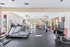 Bright, modern gym with state-of-the-art exercise equipment, cardio machines, and wellness spaces, perfect for an invigorating workout.