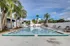 Inviting outdoor pool area with palm trees, sun loungers, and a spacious 3 ft deep swimming pool perfect for relaxation.