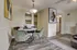 Bright and inviting dining area with modern velvet chairs, round table, and contemporary artwork for a stylish touch.