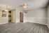 Chic apartment interior with modern laminate flooring, streamlined kitchen view, and elegant ceiling fan lighting.