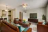 Cozy and inviting living room with stylish leather seating, elegant decor, and a modern entertainment unit, perfect for relaxation and social gatherings.