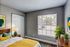 Bright and inviting bedroom with large window, modern decor, and vibrant yellow accents, creating a cozy and stylish atmosphere.