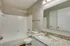 Charming bathroom with elegant granite countertop, modern fixtures, and bright lighting. Perfect blend of style and functionality.