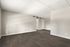 Bright and spacious room with elegant hardwood flooring and modern recessed lighting.