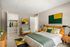Bright and modern bedroom with a luxurious bed, stylish green and yellow accents, and a spacious closet, perfect for relaxation and comfort.