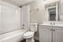 Bright and inviting bathroom with a modern bathtub, sleek vanity, and elegant fixtures.