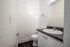 Modern bathroom with sleek sink, stylish vanity, and gleaming fixtures, perfect for a minimalist lifestyle.