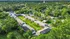 Charming apartment complex nestled in lush greenery, featuring well-maintained buildings and inviting pathways, ideal for a serene residential experience.