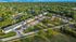 Aerial view of charming apartment complex surrounded by lush greenery and nestled in a serene neighborhood.