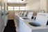 Bright and convenient community laundry room with modern washing machines, offering ample natural light and spacious layout for easy laundry days.