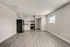 Bright and modern kitchen area with sleek stainless steel appliances, inviting wood-look flooring, and abundant natural light.