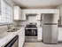 Modern kitchen with sleek stainless steel appliances, elegant granite countertops, and abundant natural light.