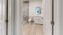 Elegant modern bathroom with sleek glass shower, pristine white fixtures, and stylish wood flooring.