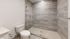 Modern bathroom with a spacious glass-enclosed shower and elegant tile design, offering a sleek and refreshing retreat.