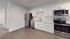 Modern kitchen with sleek stainless steel appliances, elegant white cabinetry, and polished countertops, offering a contemporary and functional space.