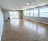 Expansive living space with tiled floors and large windows offering stunning waterfront views, perfect for a serene lifestyle.