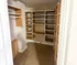 Spacious walk-in closet with modern shelving and ample storage solutions.
