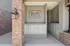 Elegant brick and stucco exterior featuring modern mailbox units at a chic downtown apartment complex.