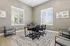 Bright, modern meeting room with a chic table, comfortable chairs, elegant wall art, and large windows offering natural light.