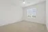 Inviting room with plush carpet, bright window, and ceiling fan, perfect for a tranquil home setting.