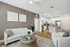 Elegant open-concept living room with cozy seating, stylish decor, and a modern kitchen island, perfect for entertaining.