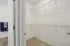 Spacious walk-in closet with modern wire shelving and soft carpeting, perfect for organized storage in a stylish apartment.
