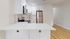 Bright and modern kitchen with sleek white cabinetry, stainless steel appliances, and elegant quartz countertops.