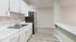 Modern kitchen with sleek stainless steel appliances, elegant white cabinetry, and stylish tile backsplash.