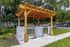 Charming outdoor grilling area with twin stainless steel barbeque stations under a stylish wooden pergola, perfect for hosting gatherings.