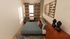 Bright and stylish bedroom featuring a cozy double bed, chic geometric curtains, and elegant decor with modern art accents, perfect for relaxation.