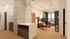 Modern apartment interior with stylish living room, cozy seating area, and elegant decor, accented by natural light and vibrant blue curtains.