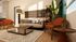 Elegant living room showcasing a cozy modern sofa, stylish orange chairs, and abundant natural light.