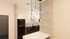Contemporary kitchen design featuring sleek black cabinetry, hexagon-tiled backsplash, and elegant pendant lighting for a modern touch.
