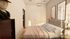 Chic bedroom with a modern aesthetic, showcasing a cozy bed, elegant artwork, and a stylish sculpture, bathed in warm natural light.