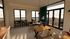 Modern dining area with sleek wooden furniture, abundant natural light, and a cozy seating nook, perfect for entertaining in style.